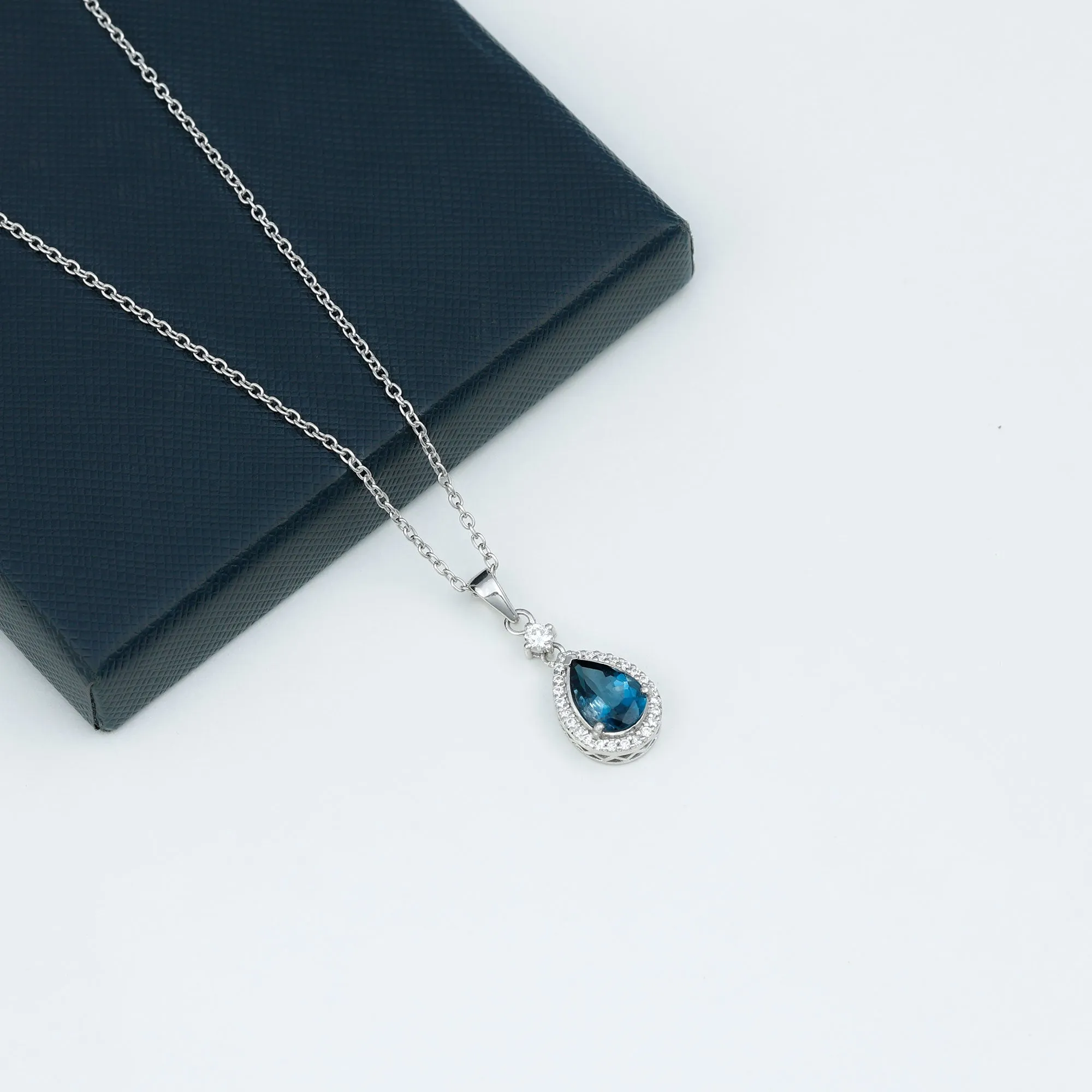 4.25 CT London Blue Topaz and Moissanite Halo Pendant Necklace in Silver