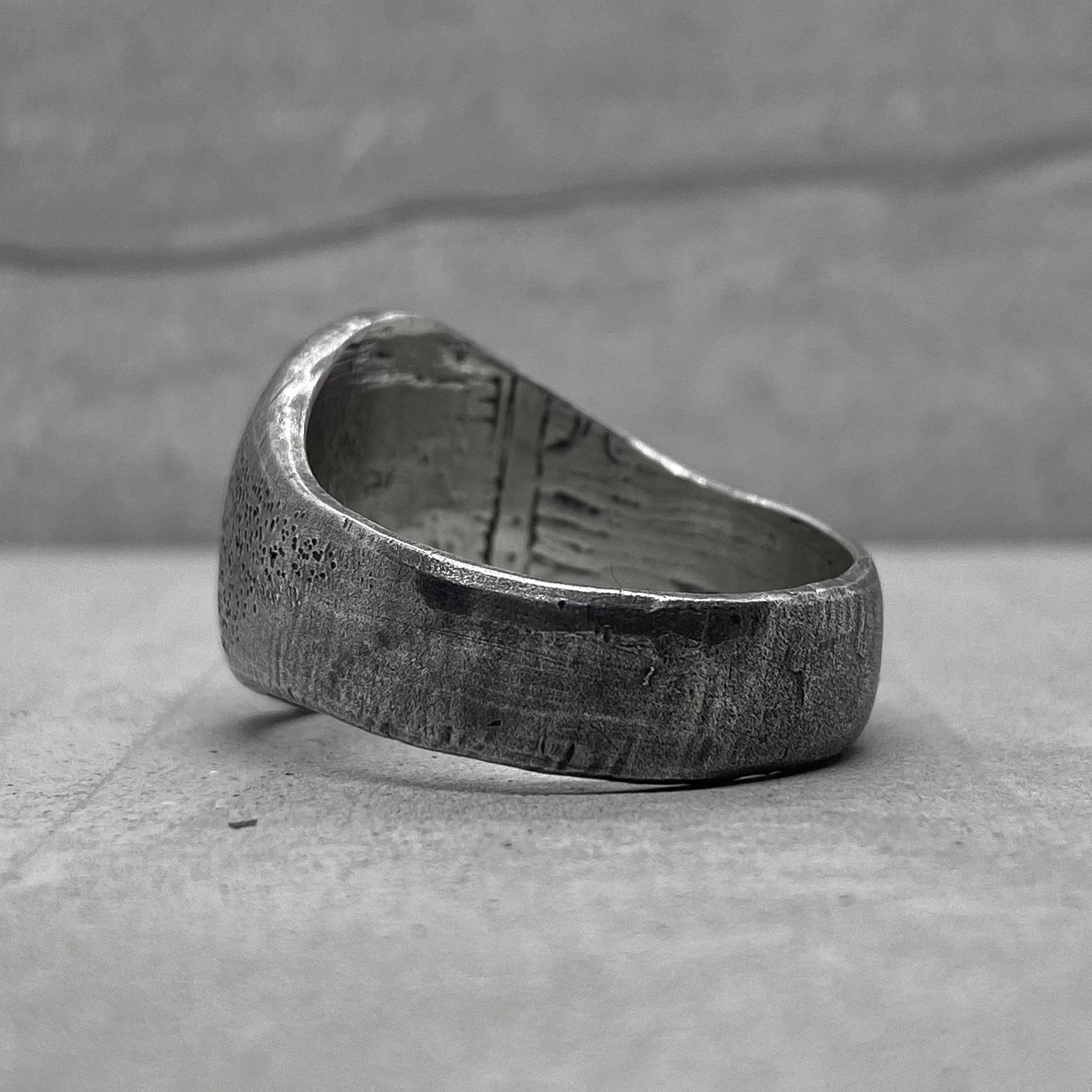 Space ring- textured oval signet ring with several black diamonds