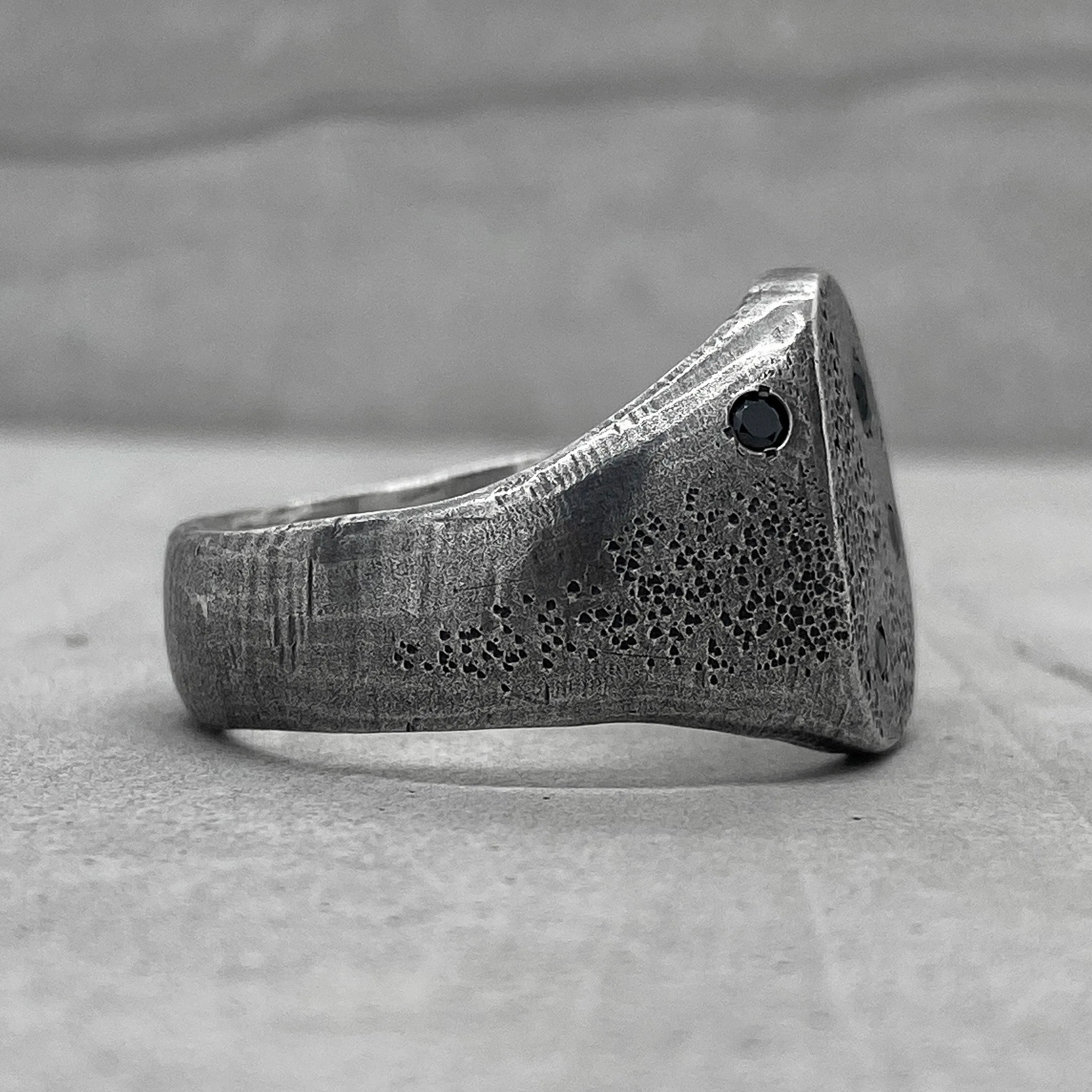 Space ring- textured oval signet ring with several black diamonds
