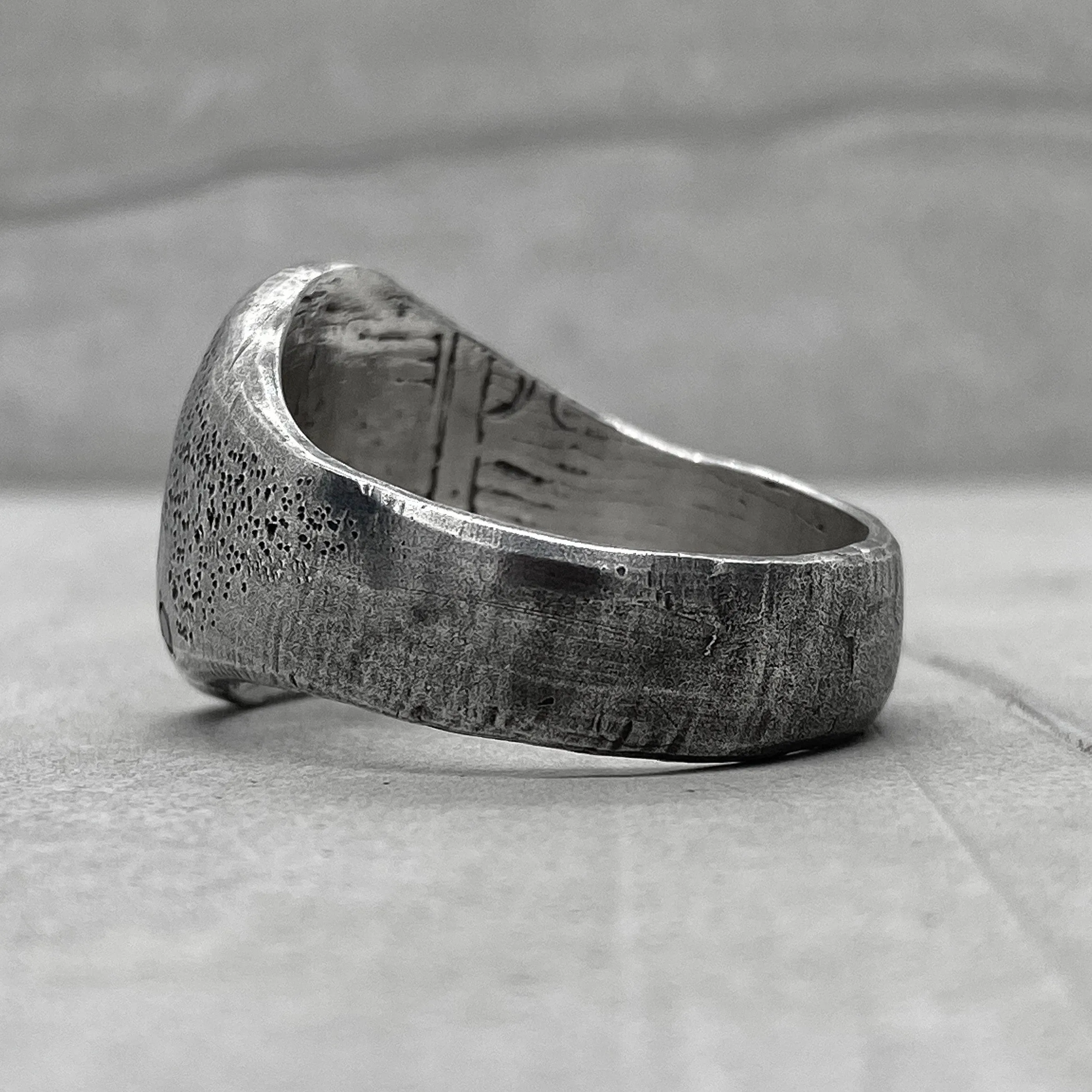 Space ring- textured oval signet ring with several black diamonds